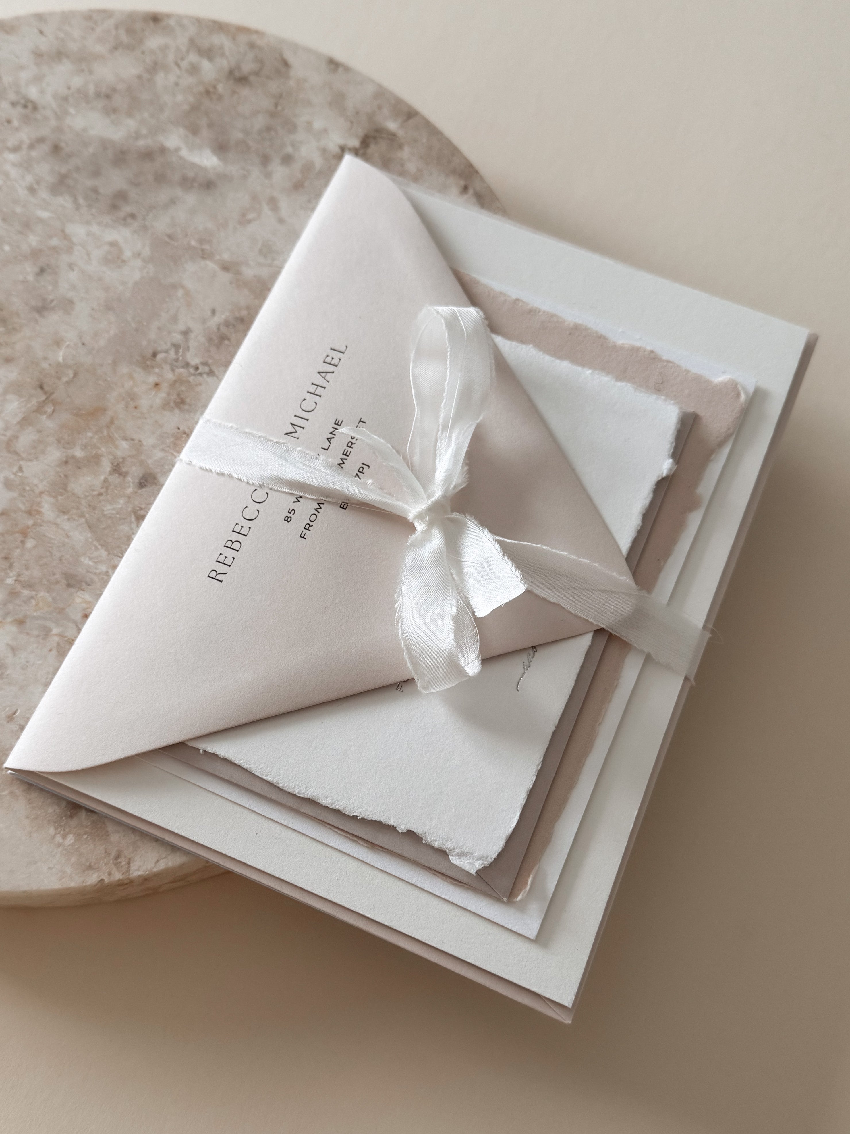 Lavender Muse sample pack showcasing printed envelope, handmade paper, letterpress and tied in a silk ribbon