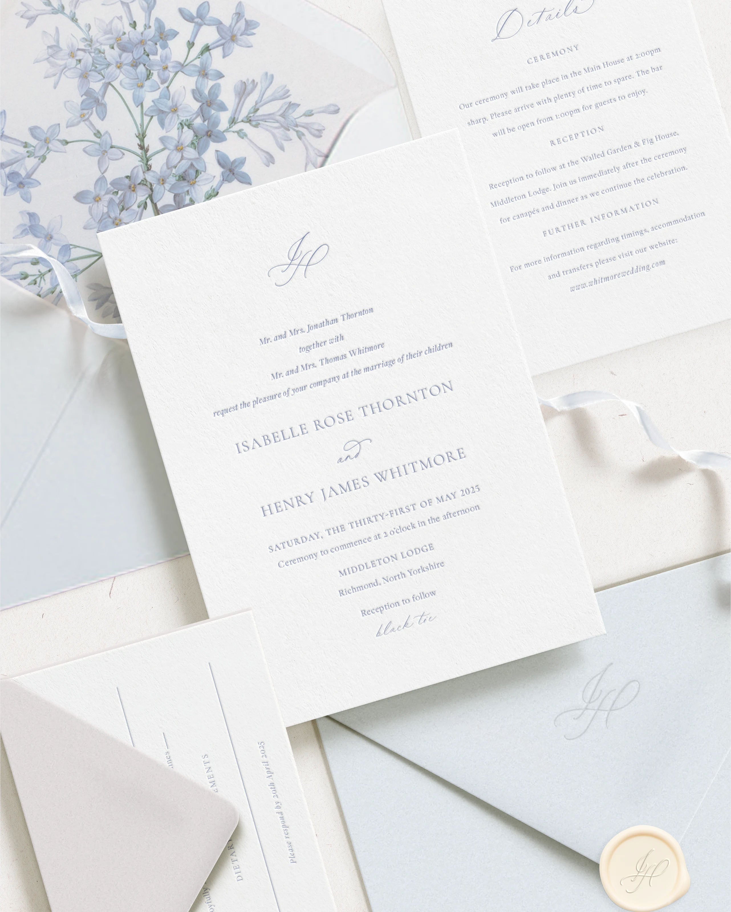Luxury wedding invitation suite featuring blue letterpress invitation and details card. RSVP card with pale grey envelope. Envelope with back flap monogram embossing, floral envelope liner and blue silk ribbon.