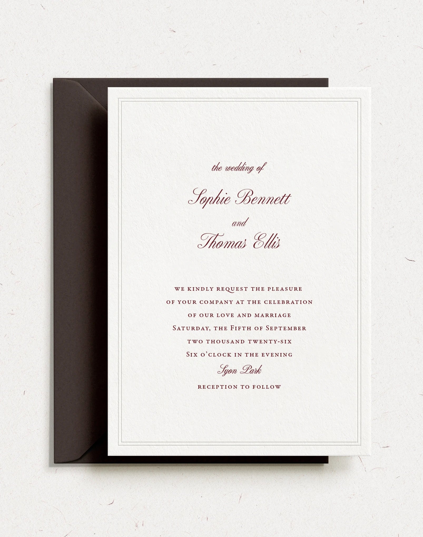 Letterpress wedding invitation with script font and blind letterpress border in a palette of brown chocolate tones.