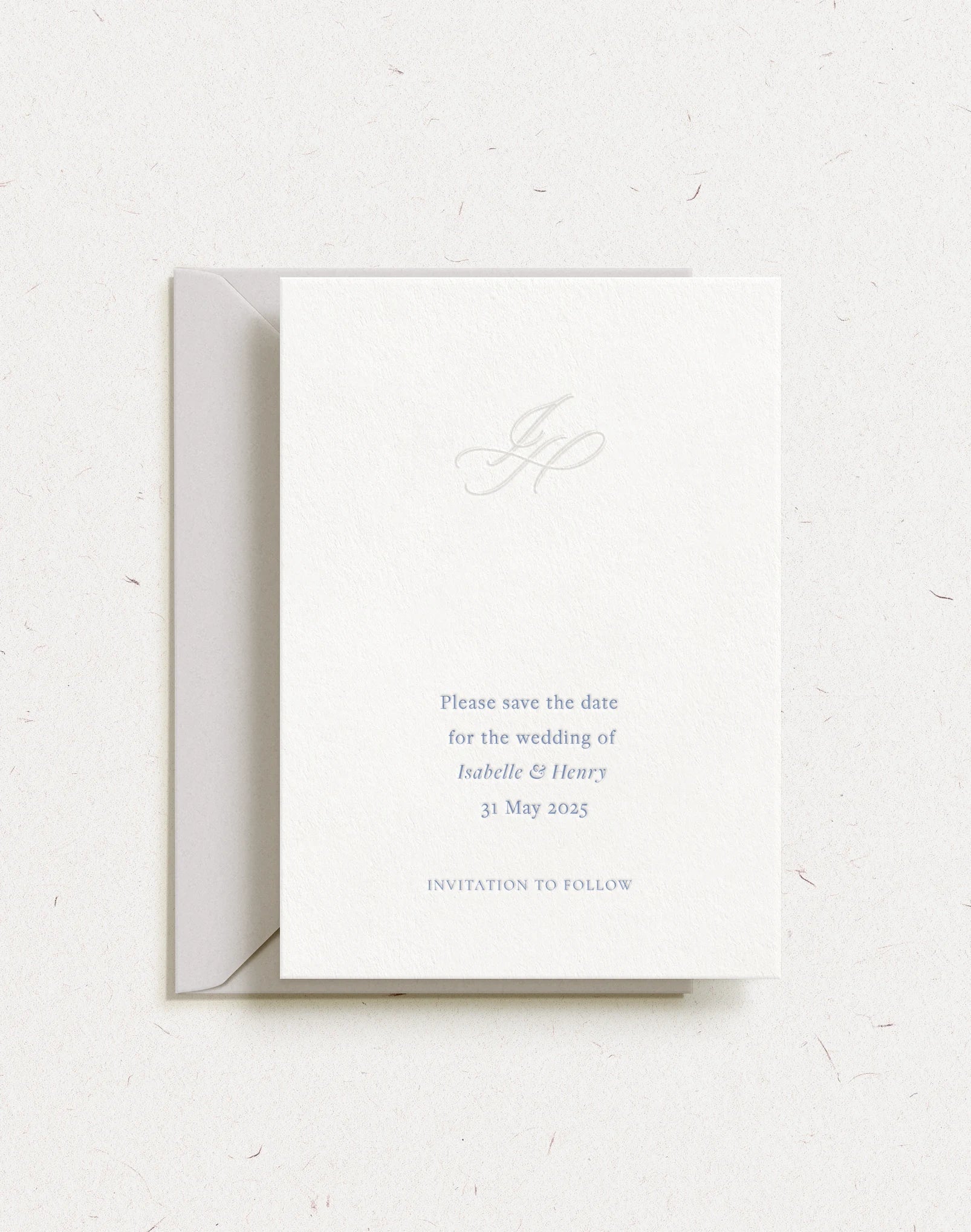 save the date with embossed monogram and letterpress text
