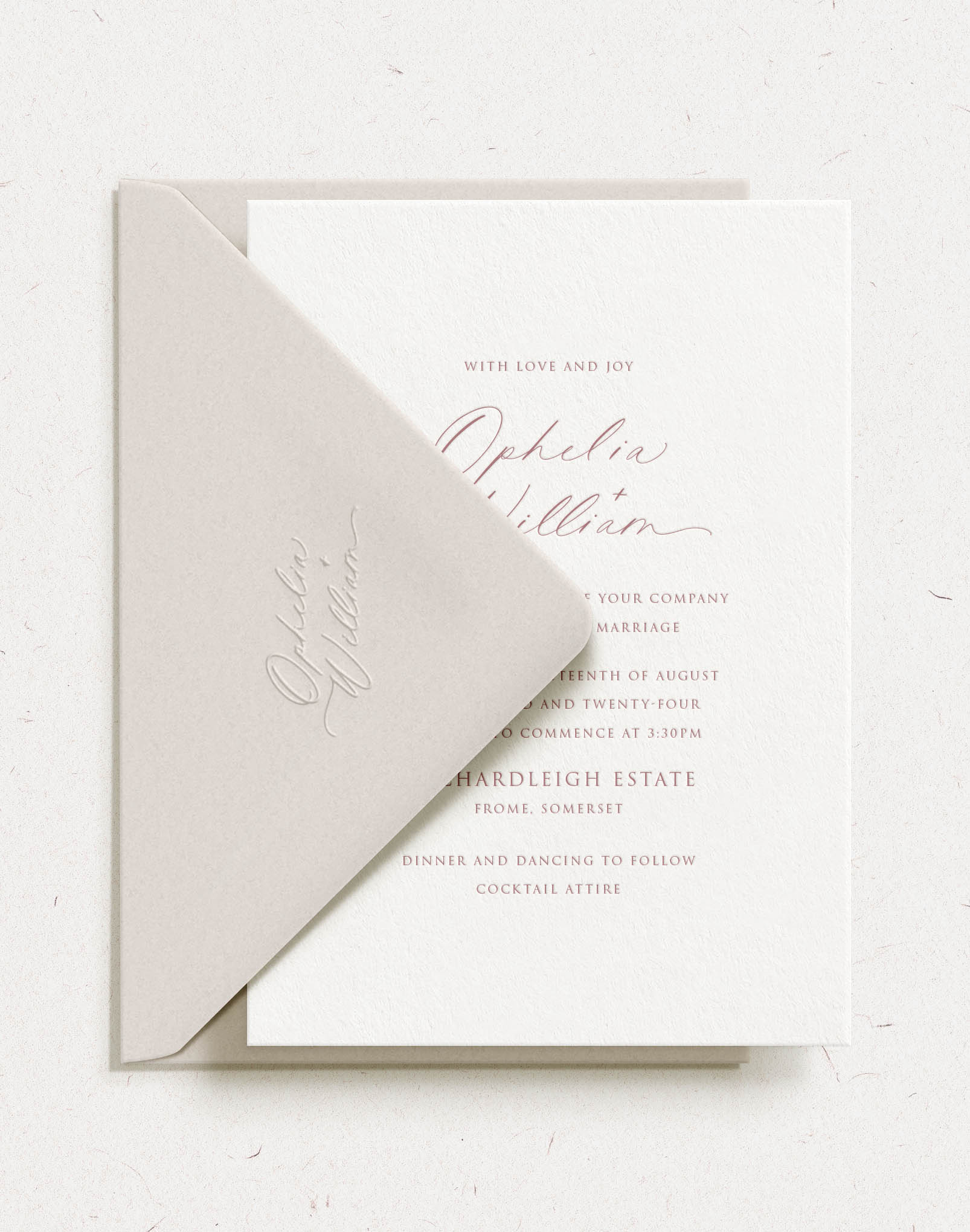 Embossed script font names on wedding envelope flap with invitation